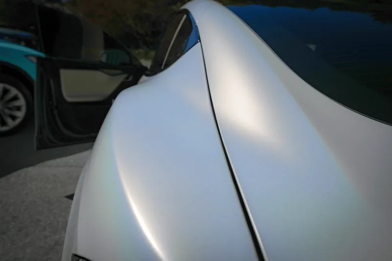 Close-up of a satin finish running along a wrapped Tesla rear quarter panel